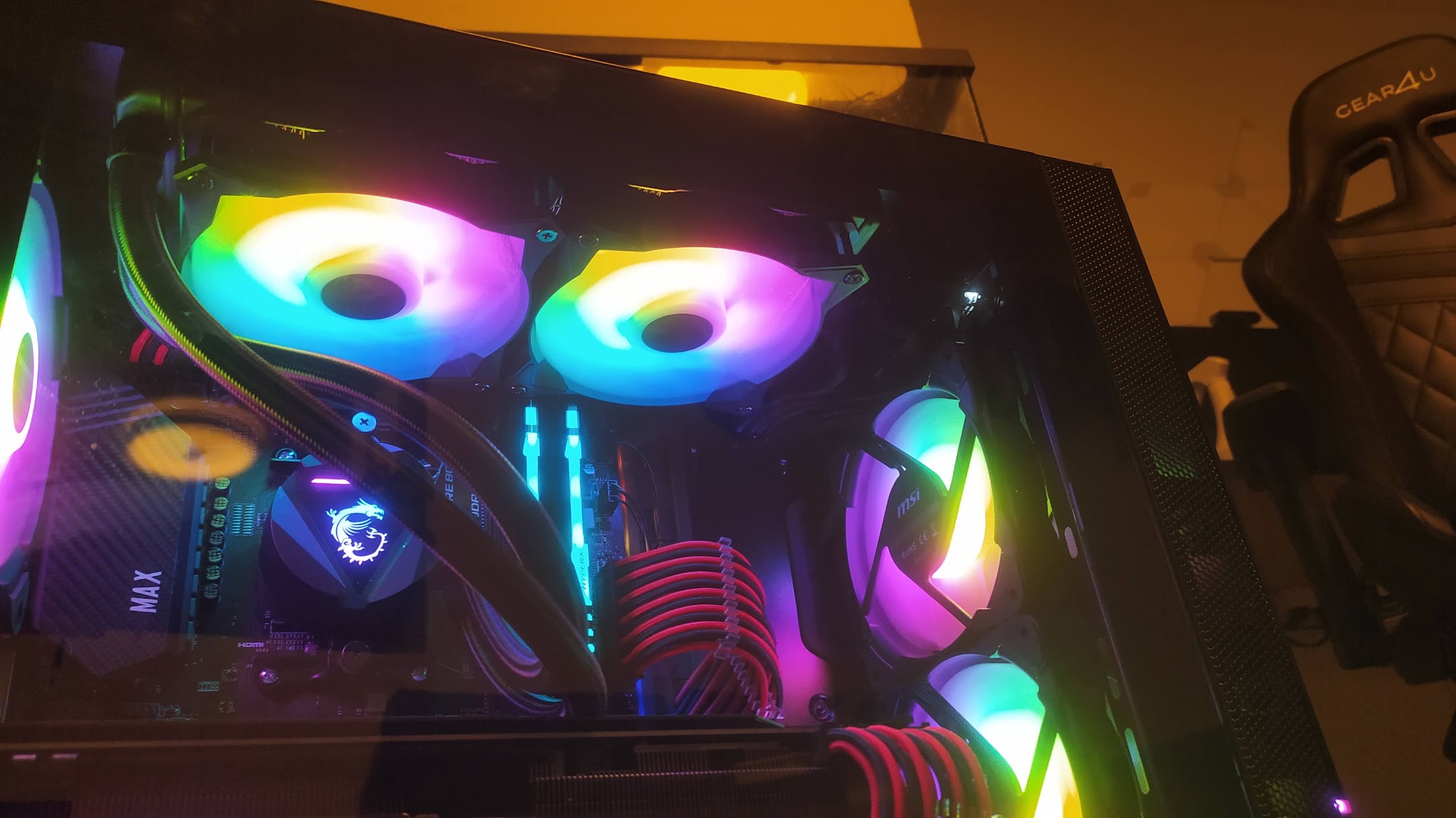RGB-lit fans and a radiator inside a glass-panel PC case